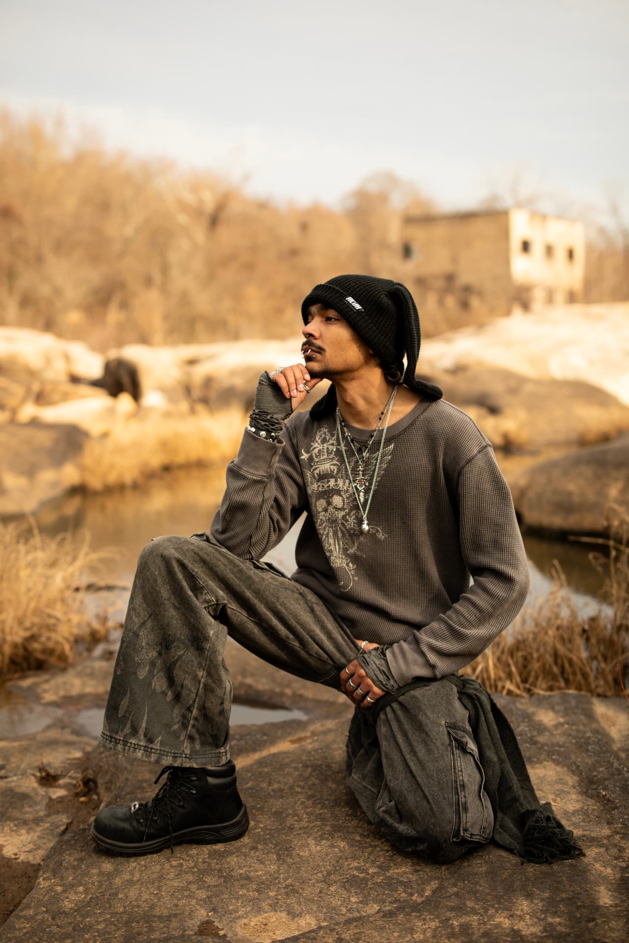 Kneeling streetwear portrait by the river at golden hour
